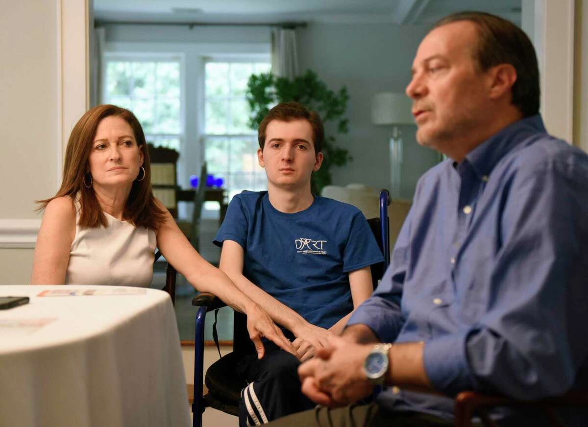 Andrea Marella and Phil Marella chat with their son Andrew, center, 20, at their home in Greenwich, Conn. Monday, Sept. 23, 2019. Andrew has a rare progressive genetic disorder called Niemann-Pick disease type C (NPC), which took the life of his sister, Dana, in 2013. The Marella's non-profit Dana?'s Angels Research Trust (DART) raises money to research the disease and is holding the DART to the Finish charity walk at Greenwich Point Park on Saturday, Oct. 5.