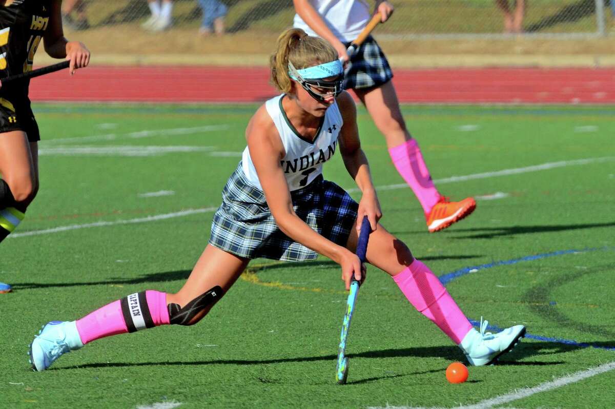 Gilford’s Ella Stanley passes the ball during field hockey action against Hand in Guilford in October.