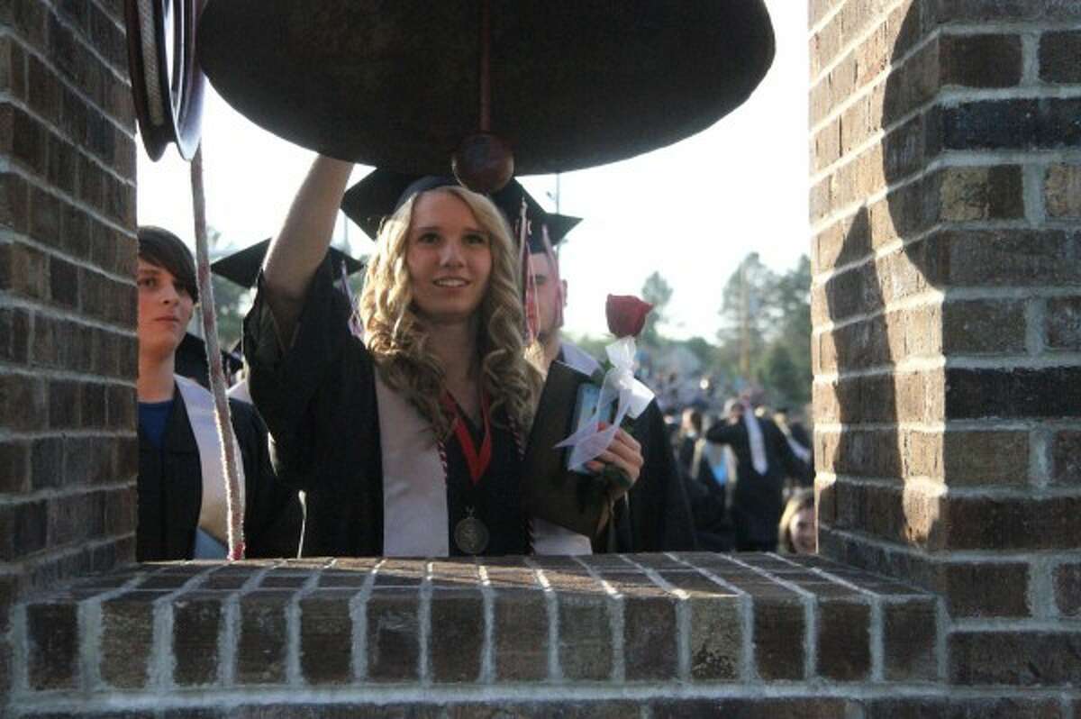 Mickayla Crandall rings the Reed City High School victory bell after graduation, a tradition at the school for the new graduates once the ceremony is completed.