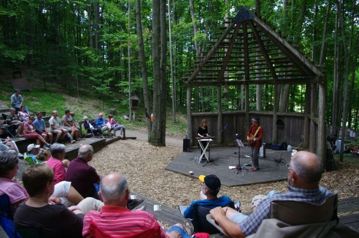 The rustic atmosphere in the woods at Crystal Mountain Resort lends to the ambiance of the Michigan Legacy Art Park Summer Sounds concerts. (Dave Yarnell/News Advocate)