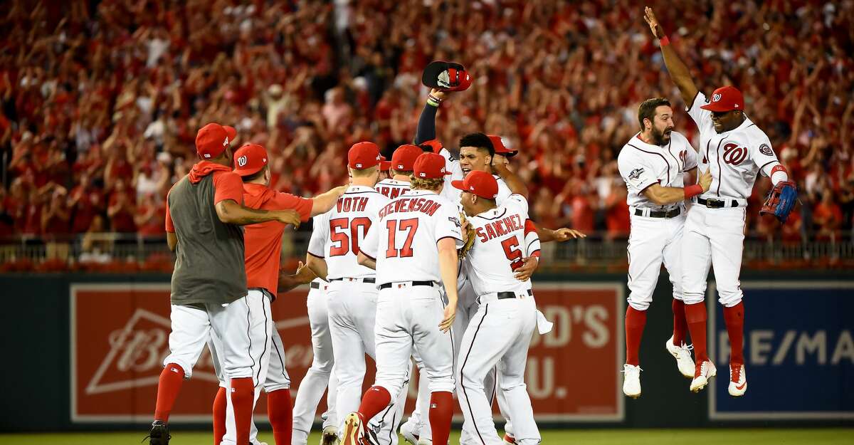 WASHINGTON, DC - OCTOBER 01: Juan Soto #22 of the Washington Nationals celebrates with his teammates after defeating the Milwaukee Brewers with a score 4 to 3 in the National League Wild Card game at Nationals Park on October 01, 2019 in Washington, DC. (Photo by Will Newton/Getty Images)