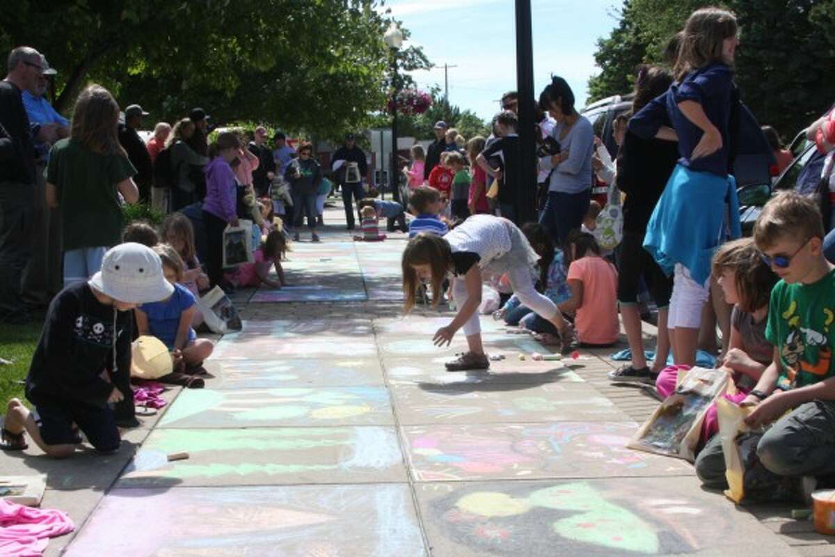 About 50 children participated in the annual Manistee Forest Festival Chalk Art Contest on Wednesday. The theme this year was trees. (Justine McGuire/News Advocate)