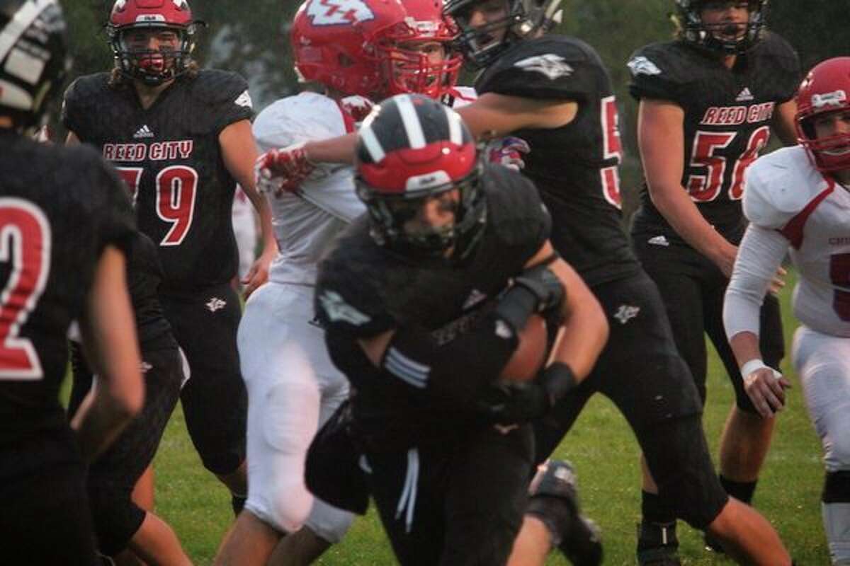 Reed City's Payton Hansen bursts through the line for a 1-yard touchdown run against Chippewa Hills. (Pioneer photo/John Raffel)