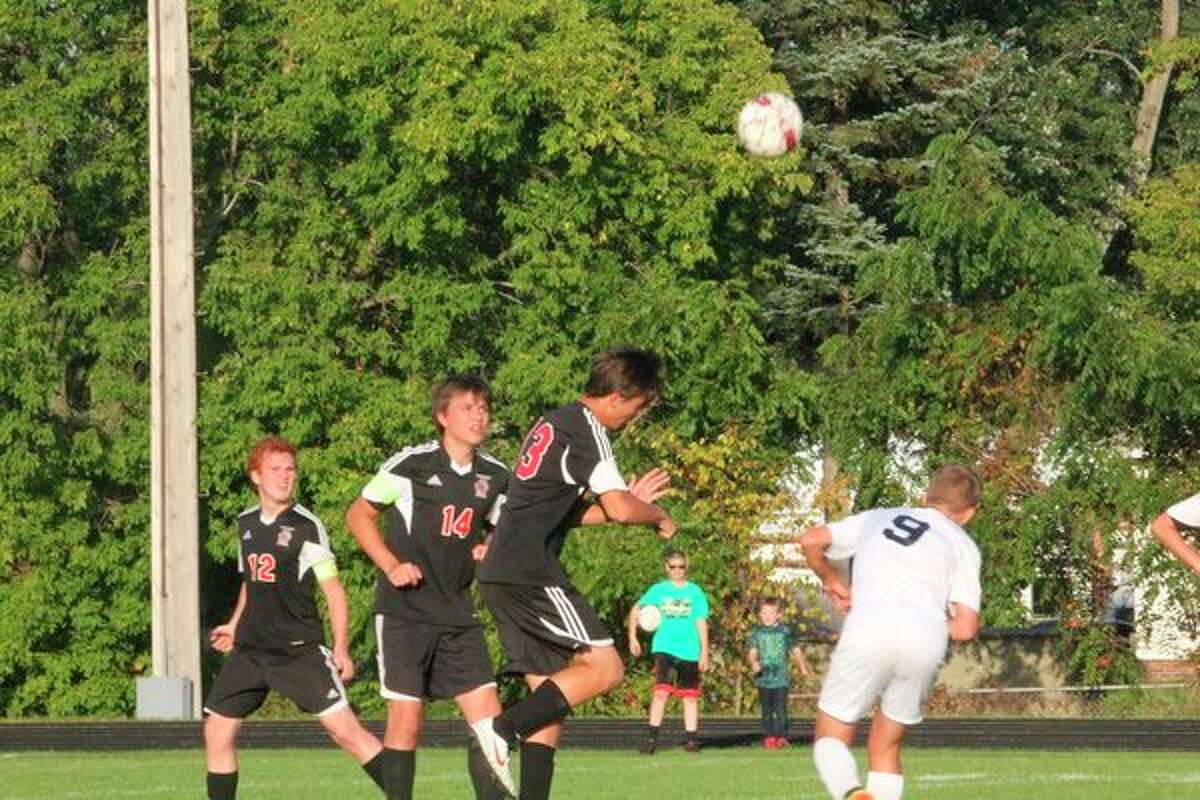 Reed City's Porter Seltfridge heads the ball against Lakeview. (Herald Review photo/John Raffel)