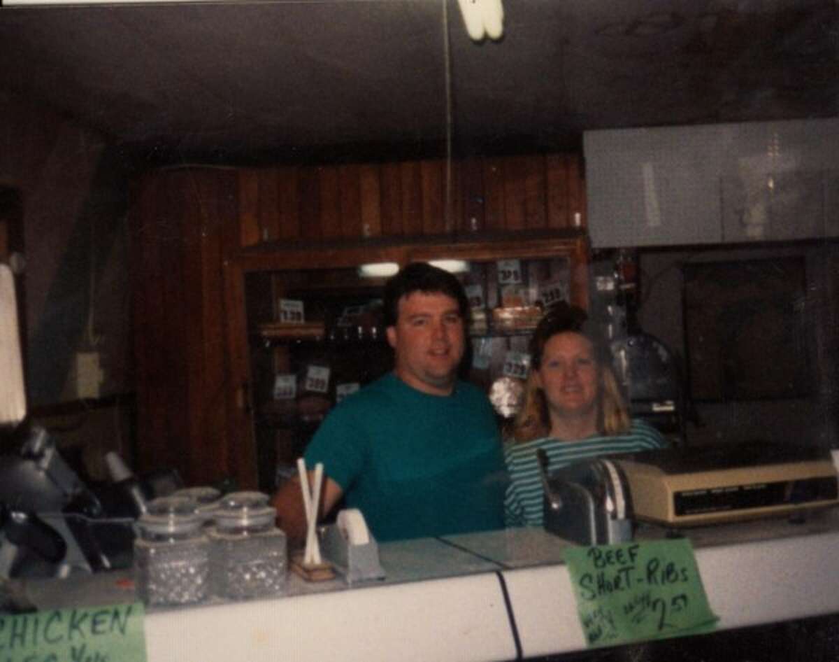 Jim Tighe and Merrill Tighe, new owners of the M-55 Market in Wellston, stand behind the meat counter after taking ownership of the store on March 1, 1985.