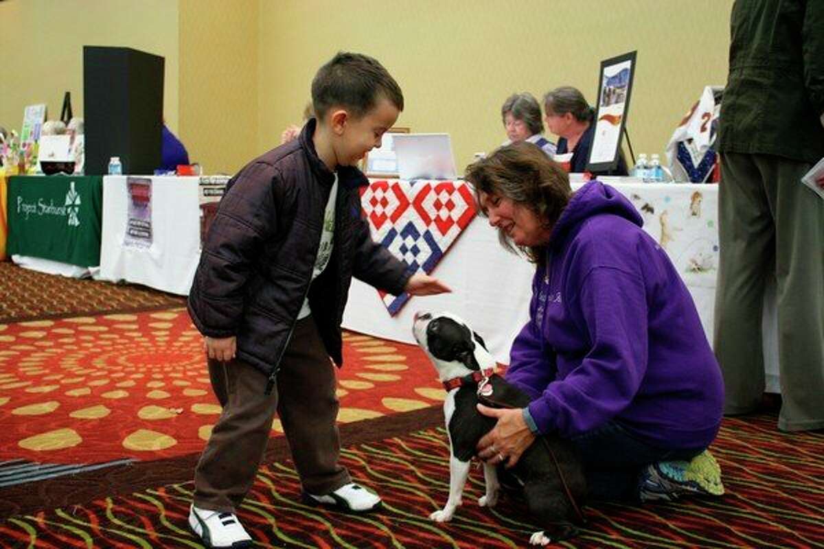 In addition to assisting residents and pets in Mecosta, Osceola and Lake counties, the volunteers with the Riley MacKenzie Fund attend area schools and events with dogs to teach people how to take care of and interact with pets. People can show their support to the organization on Oct. 5 at the Riley MacKenzie Fund 10th Anniversary Fundraiser. (Herald Review file photo)