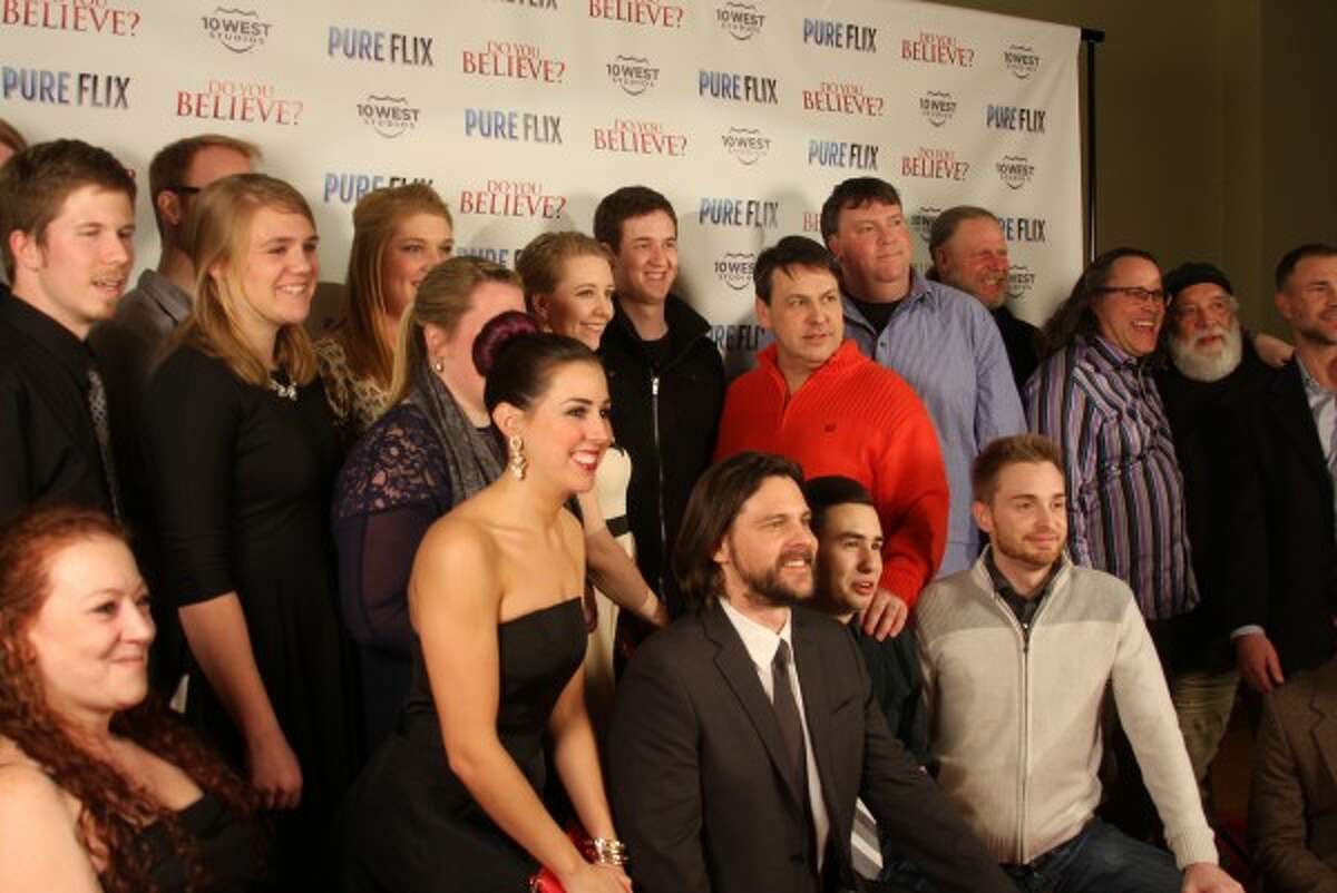 Director of "Do You Believe?" Jonathan Gunn (center front row) poses with crew members of the film before the film's premiere Friday at the Ramsdell Theatre in Manistee. Part of the film was shot in Manistee by 10 West Studios, a local film production company, particularly at the U.S. 31 bridge, which was closed for nine days in October. (Sean Bradley/News Advocate)