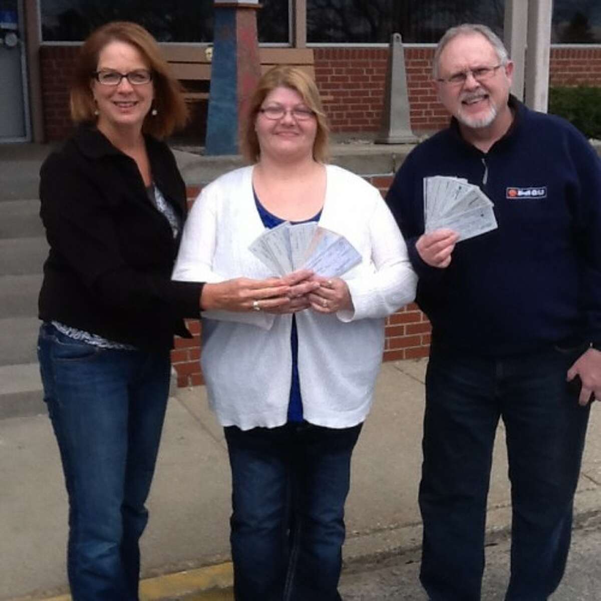 Judy Crockett, co-founder of 100 Women Who Care Manistee County, poses with Angela Beneke and Mike Woroniak, of StonesHouse Recovery of Manistee County, as they fan out checks donated to StonesHouse through the care group's second quarter meeting last week. (Courtesy photo)