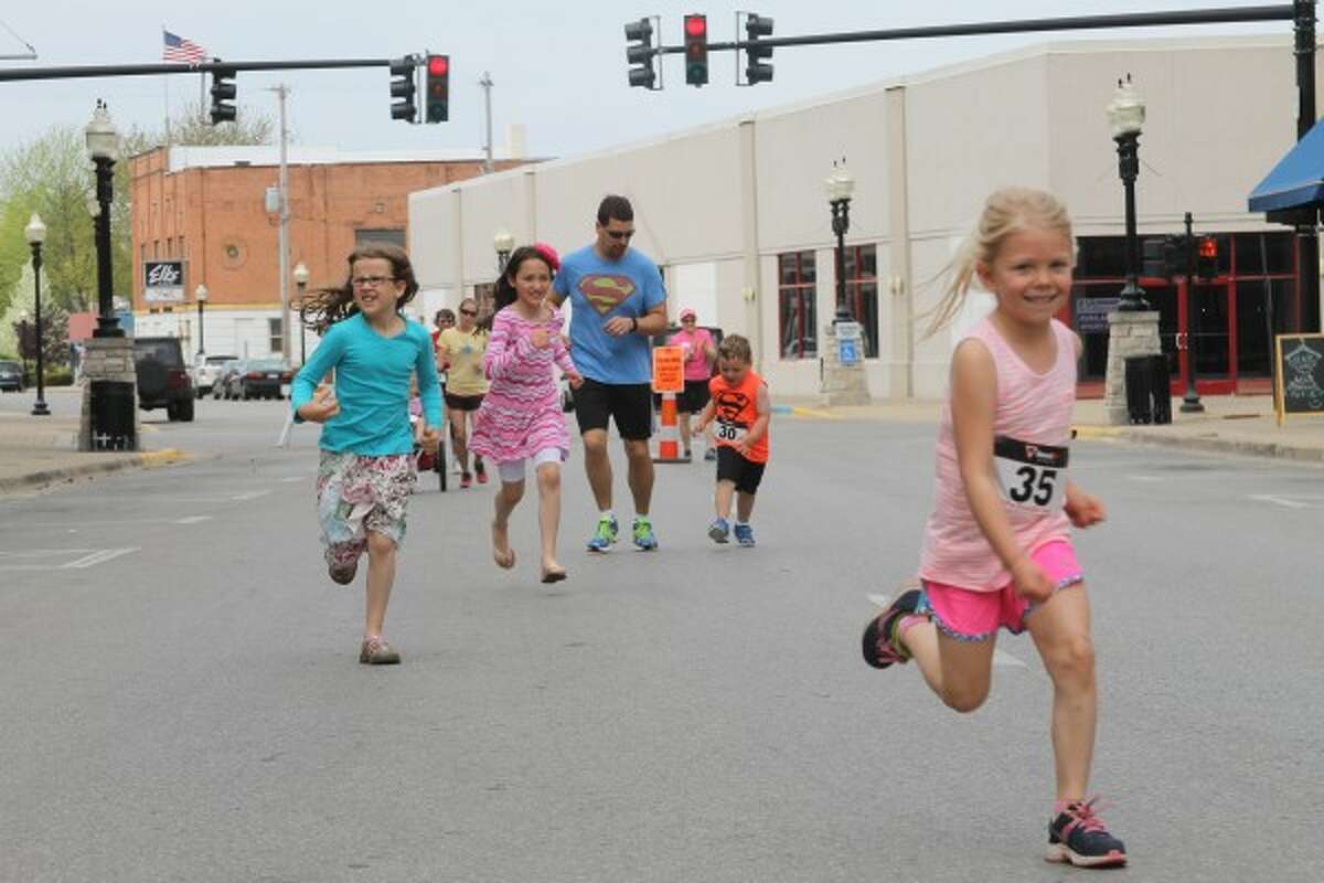 A group of children run down River Street during the first HAM It Up Kid's Fun Run, which the District Health Department No. 10 Live Well Campaign was involved in. (File Photo)