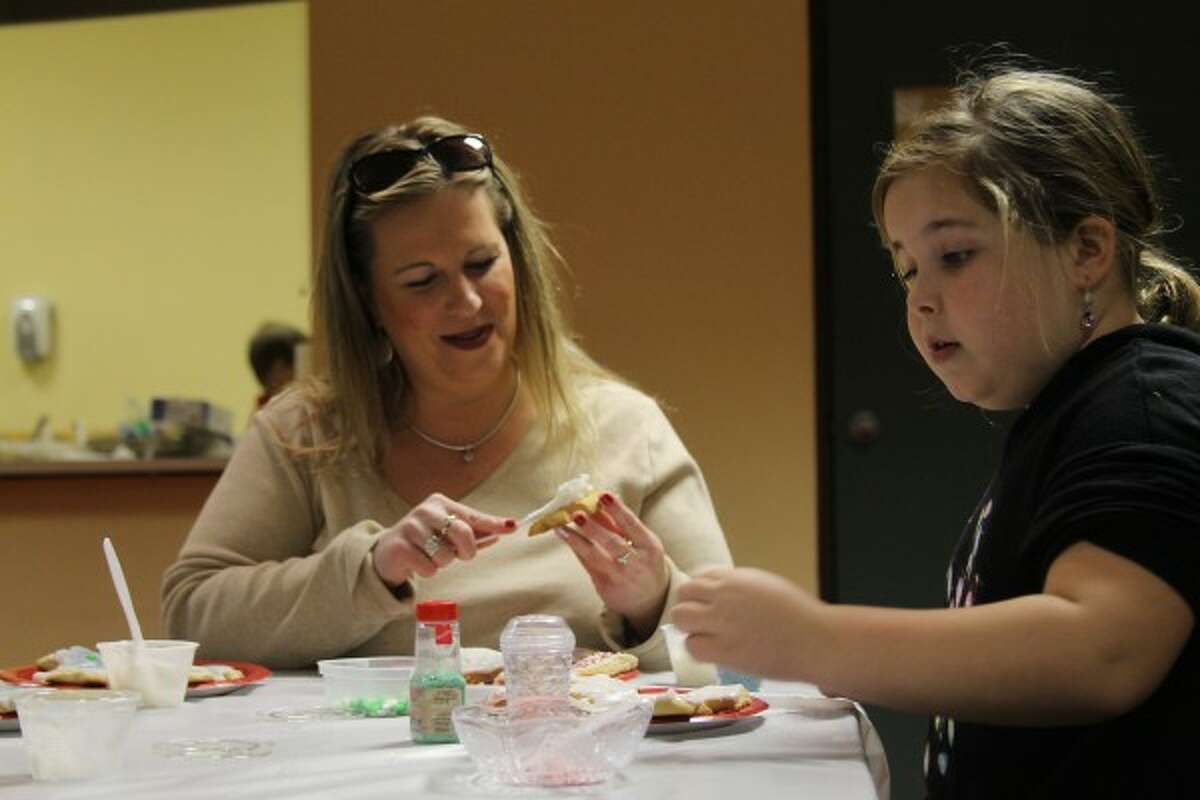 During the Cookie Fun for Everyone event on Friday at the Manistee Inn and Marina, Manistee residents Angelia Krause and her daughter Alexis decorated cookies. The event, where people can decorate and buy cookies, raises funds for the Manistee County Habitat for Humanity. (Sean Bradley/News Advocate)