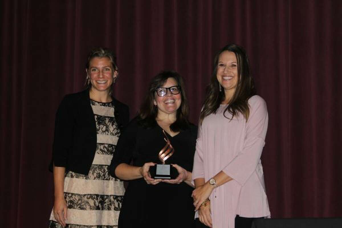 FILE -- The Small Business of the Year award went to The Fillmore during the Manistee Area Chamber of Commerce's annual business awards in November 2017 at the Little River Casino Resort. Pictured (from left) are Crystal Young, master of ceremonies; Nichole Knapp, owner of the Fillmore; and Stacie Bytwork, chamber director. (Michelle Graves/News Advocate)