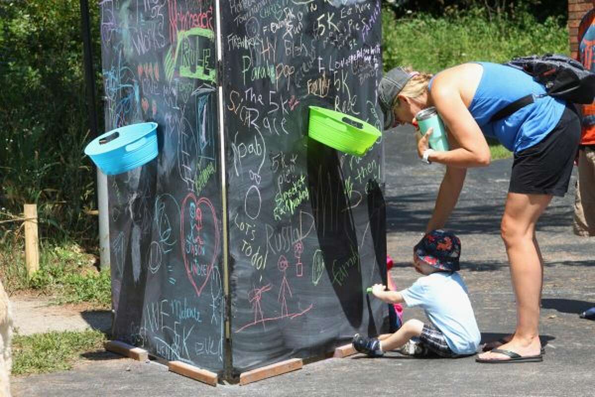 Arcadia Daze visitors were invited to write why they love the festival, on a chalk board displayed outside of the fire hall. (Ashlyn Korienek/News Advocate)