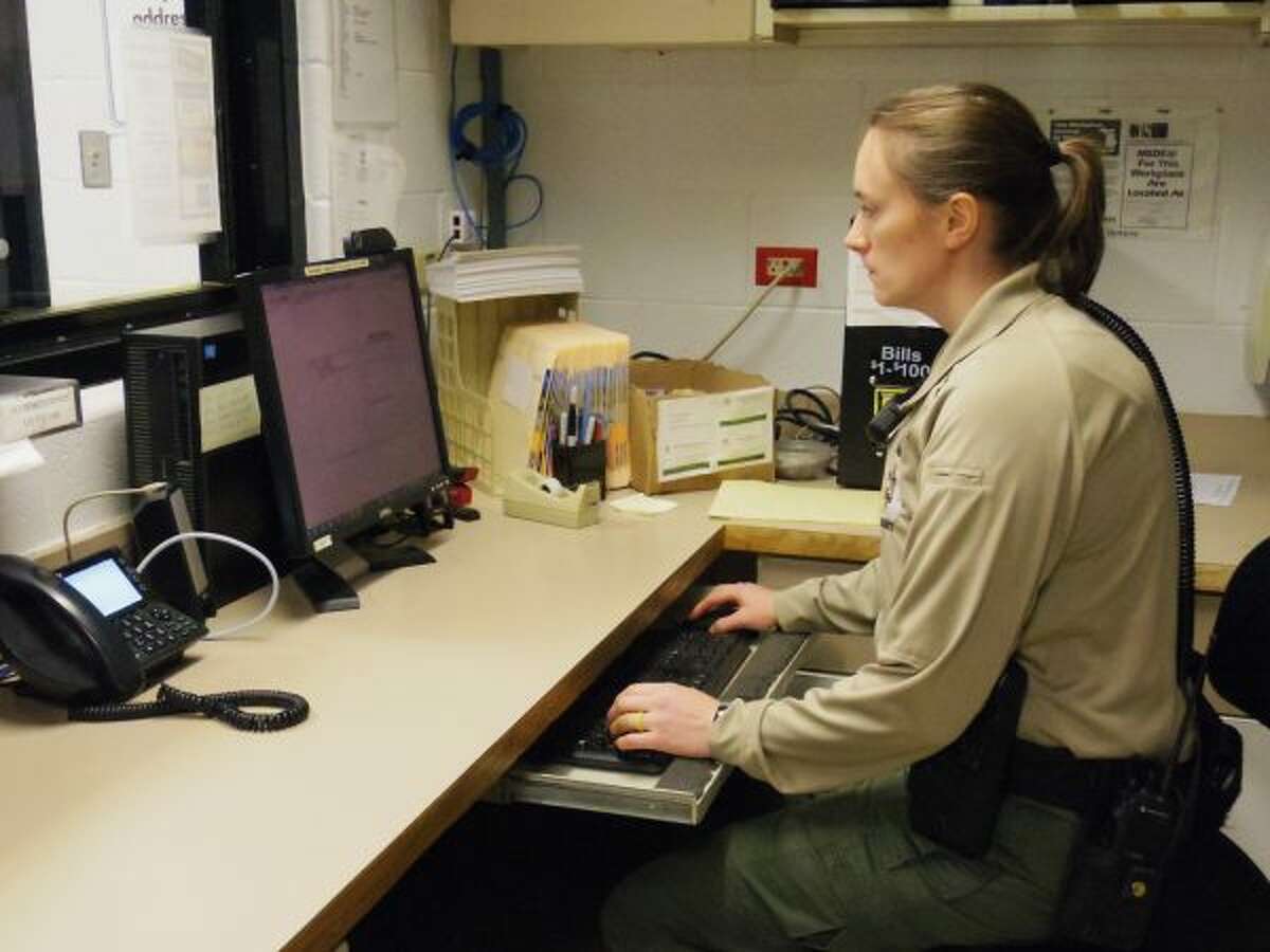 Corrections officer Ella Gannon works on the computer, completing daily duties of the job on a Monday morning. (Ashlyn Korienek/News Advocate)