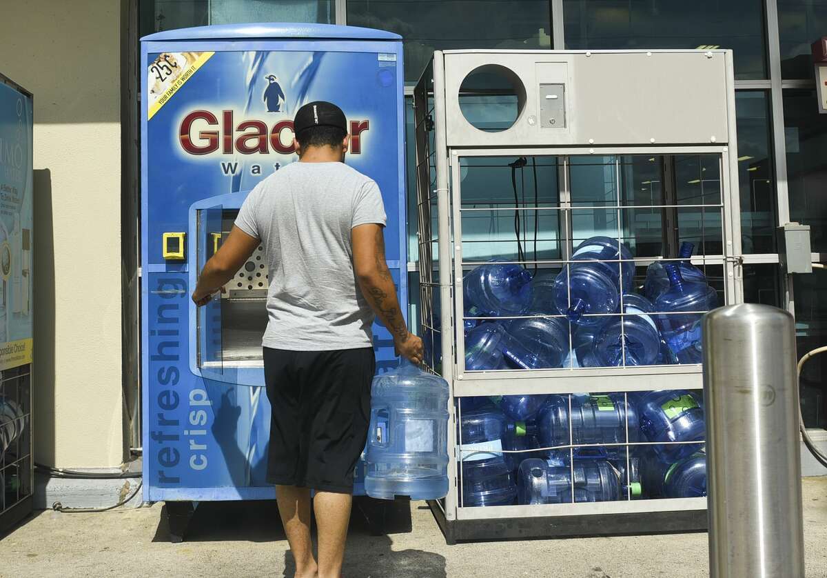 A Laredoan goes to refill a jug of water at a water refill station in North Laredo, Sunday, Sep. 29, 2019.