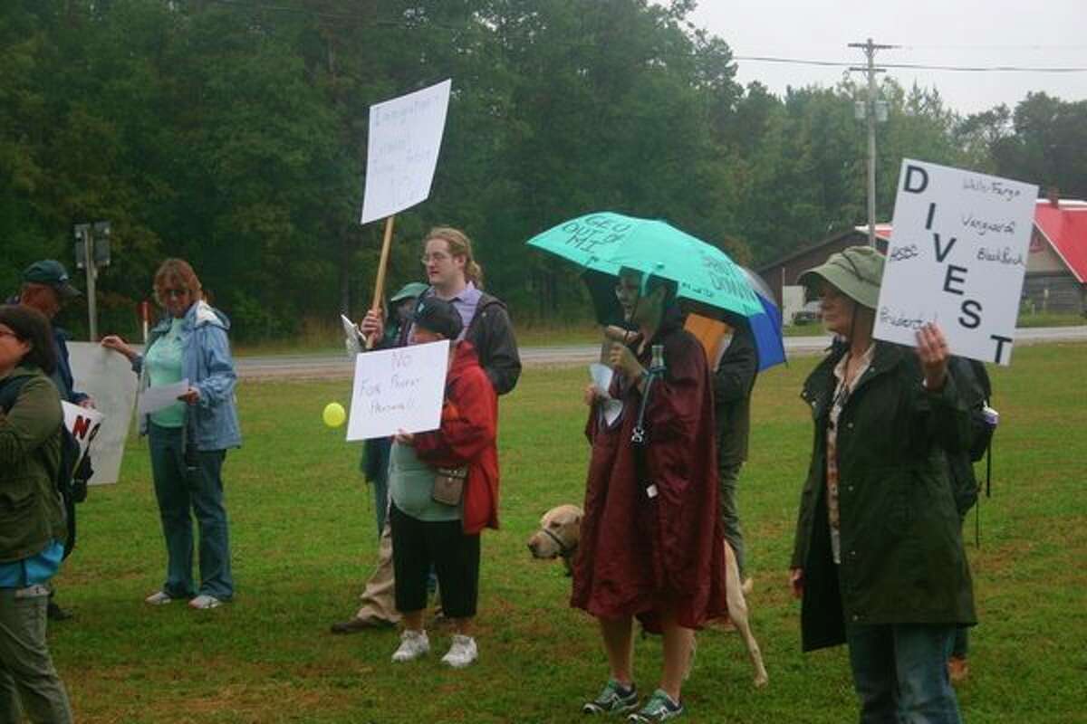 Members of the Lake County Democratic Party braved the weather to join in the protest opposing the opening of the North Lake Correctional facility in Baldwin on Tuesday, Oct. 1. (Star photo/Cathie Crew)