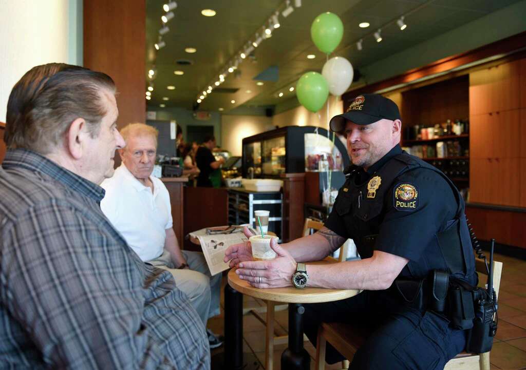 <p>Greenwich Police Officer Keith Hirsch chats with locals at the Coffee with a Cop event.</p>