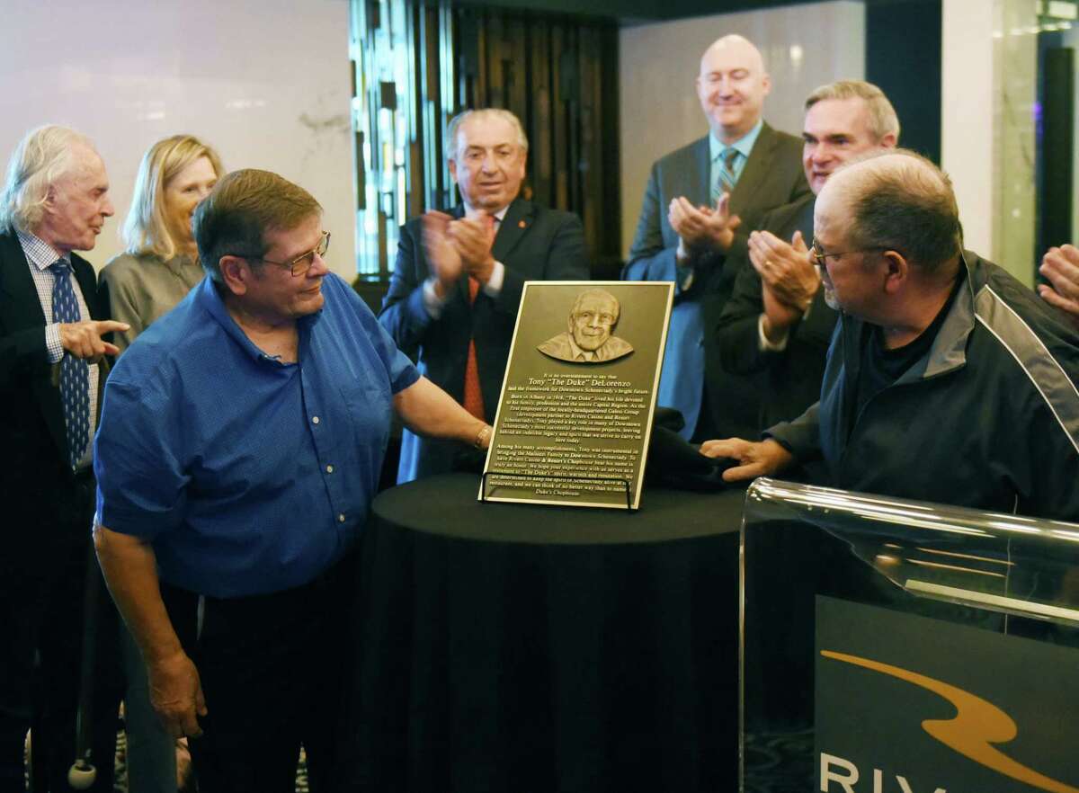 Tom, left, and Bob DeLorenzo, right, look at a plaque honoring their late farther, Tony ?’The Duke?“ DeLorenzo, the first person hired by the Galesi Group, during a ceremony on Wednesday, Oct. 2, 2019, at Rivers Casino's Duke?•s Chophouse in Schenectady, N.Y. The restaurant namesake was a key figure in the company. Galesi Group is celebrating its 50th anniversary. (Will Waldron/Times Union)
