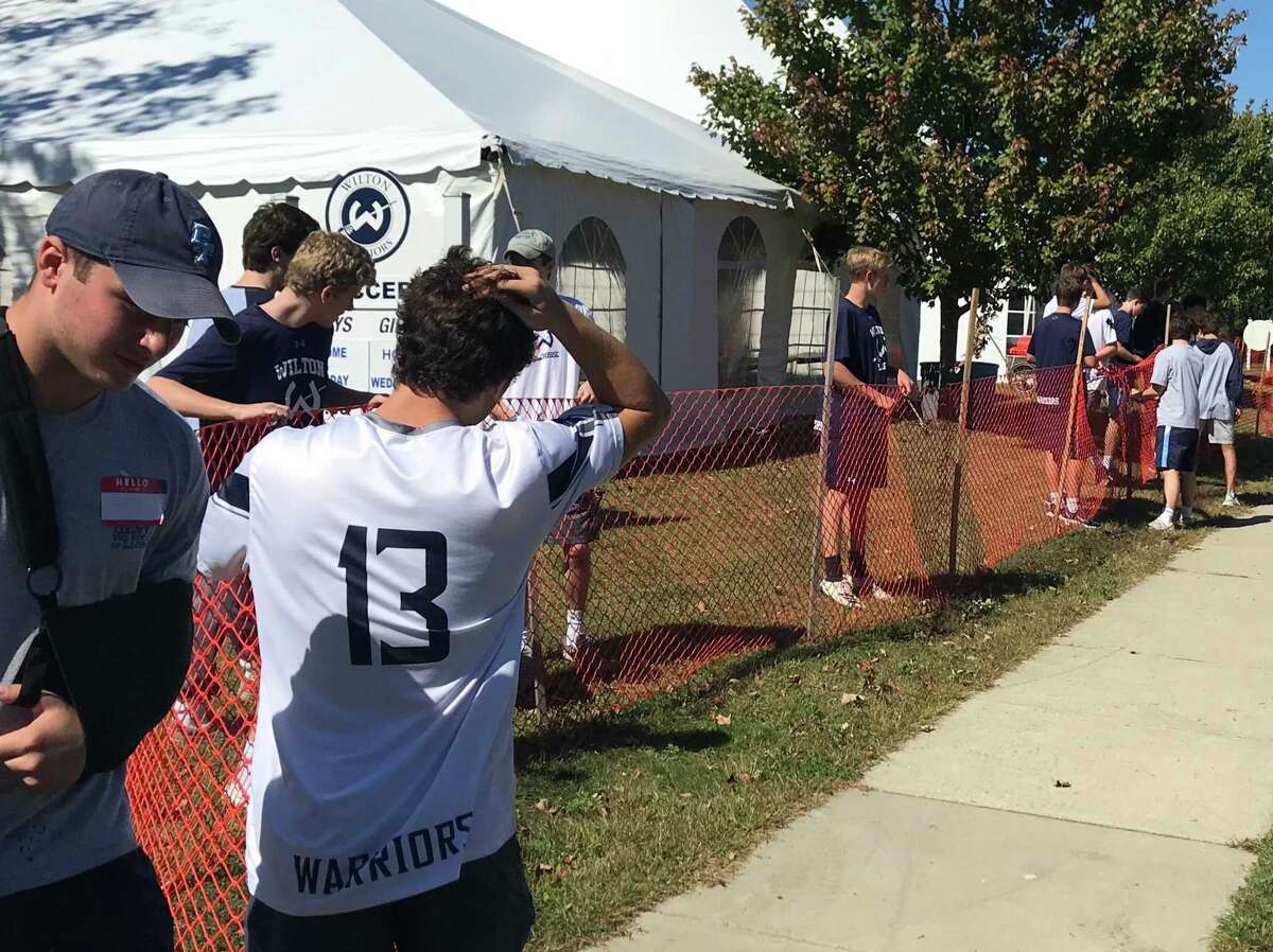 Members of Wilton High School's boys lacrosse teams help Minks to Sinks volunteers set up the weekend of Sept. 28-29.