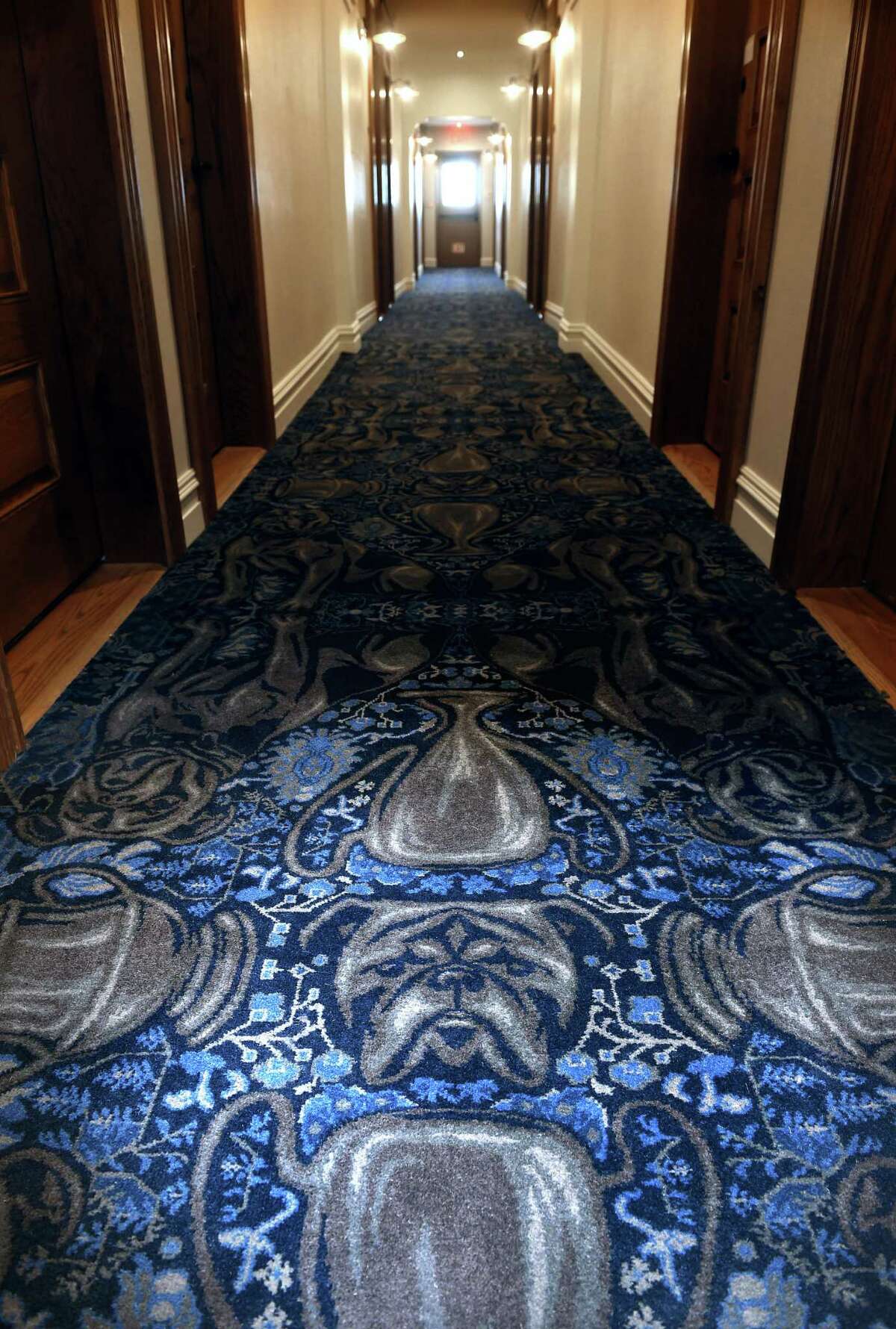 The Yale University mascot, Handsome Dan, as well as Mory’s Cups decorate custom-made carpeting in the hallways at the Graduate Hotel, formerly the Hotel Duncan, on Chapel Street in New Haven on October 2, 2019.
