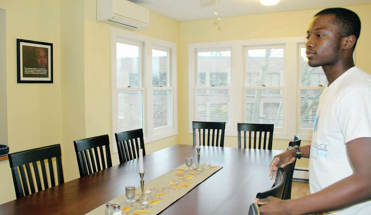 Rajon Mitchell in the dining room of the A Better Chance (ABC House) in New Canaan, Connecticut on Jan. 23, 2017, when a dining room table was custom-made for the house, and donated. The nonprofit organization’s abode will now also receive a new roof, that is also being donated, from a roofing, and siding company this month, October, to further cover the inside of the dwelling. Erin Kayata / Hearst Connecticut Media