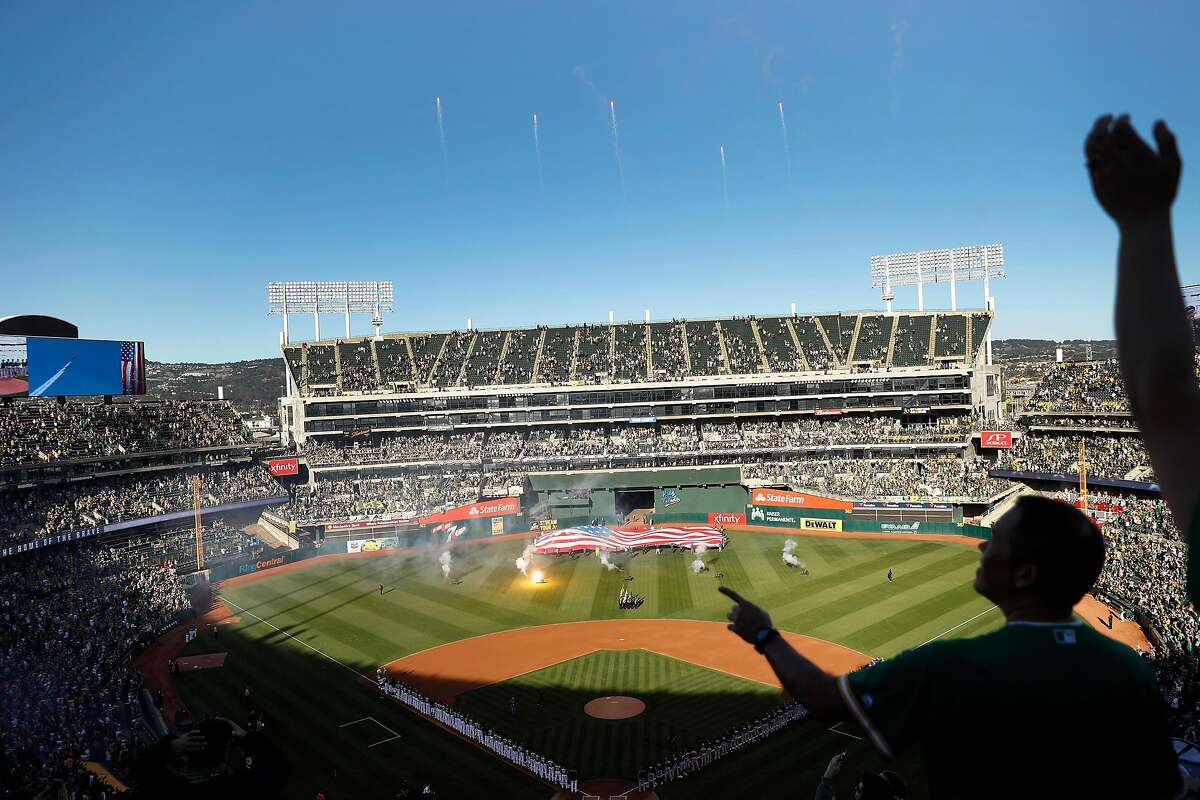Fans cheer a flyover during the national anthem before Oakland Athletics play Tampa Bay Rays in American League wild card game at Oakland Coliseum in October 2019.