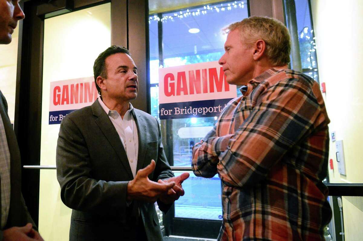Mayor Joe Ganim, left, chats with Stress Factory comedy club owner Vinnie Brand during a re-election fundraiser for Ganim at the club in Bridgeport, Conn., on Wednesday Oct. 2, 2019.