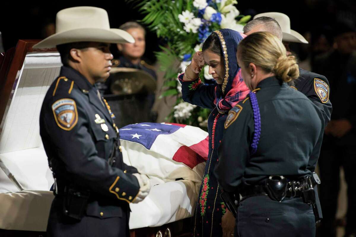 Harwinder Kaur Dhaliwal, widow of Harris County Sheriff's Deputy Sandeep Dhaliwal salutes as she honors her husband during his funeral at Berry Center on Wednesday, Oct. 2, 2019, in Houston. Dhaliwal was killed in the line of duty Friday, when he was shot and killed during a traffic stop.