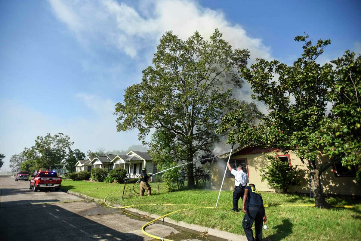 Port Arthur firefighters work on extinguishing remaining flames and hot spots after they responded to an abandoned house that was on fire in the 1000 block of Herget Ave. in Port Arthur Wednesday afternoon. Photo taken on Wednesday, 10/02/19. Ryan Welch/The Enterprise