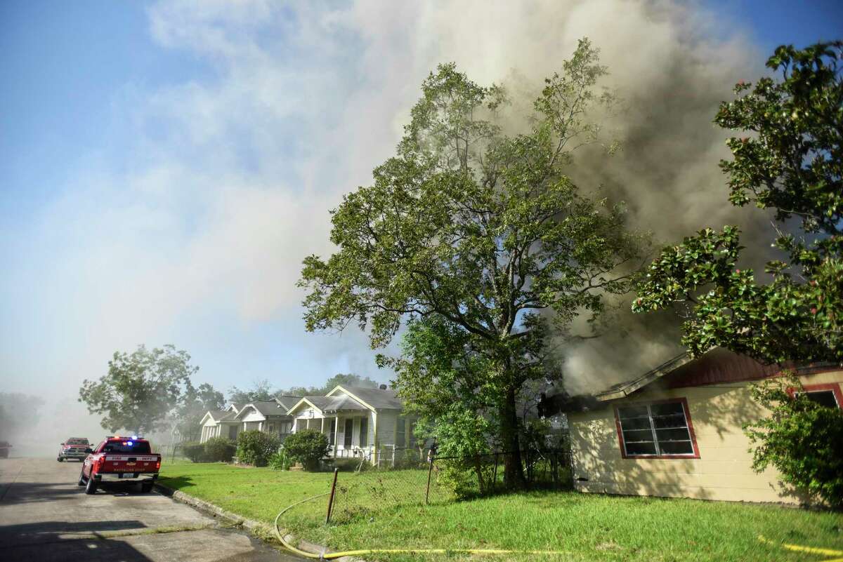 Port Arthur firefighters work on extinguishing remaining flames and hot spots after they responded to an abandoned house that was on fire in the 1000 block of Herget Ave. in Port Arthur Wednesday afternoon. Photo taken on Wednesday, 10/02/19. Ryan Welch/The Enterprise