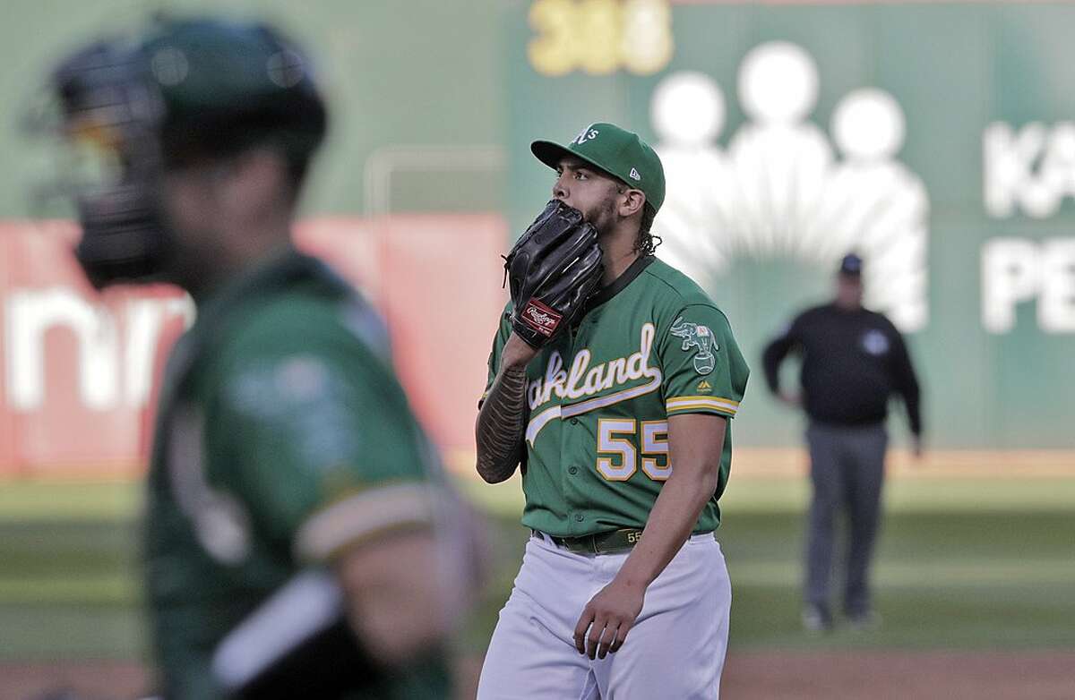 Sean Manaea (55) walks off the field after the second inning with the A's trailing 3-0 as the Oakland Athletics played the Tampa Bay Rays at the Oakland Coliseum in the AL Wild Card playoff game in Oakland, Calif., on Wednesday, October 2, 2019.