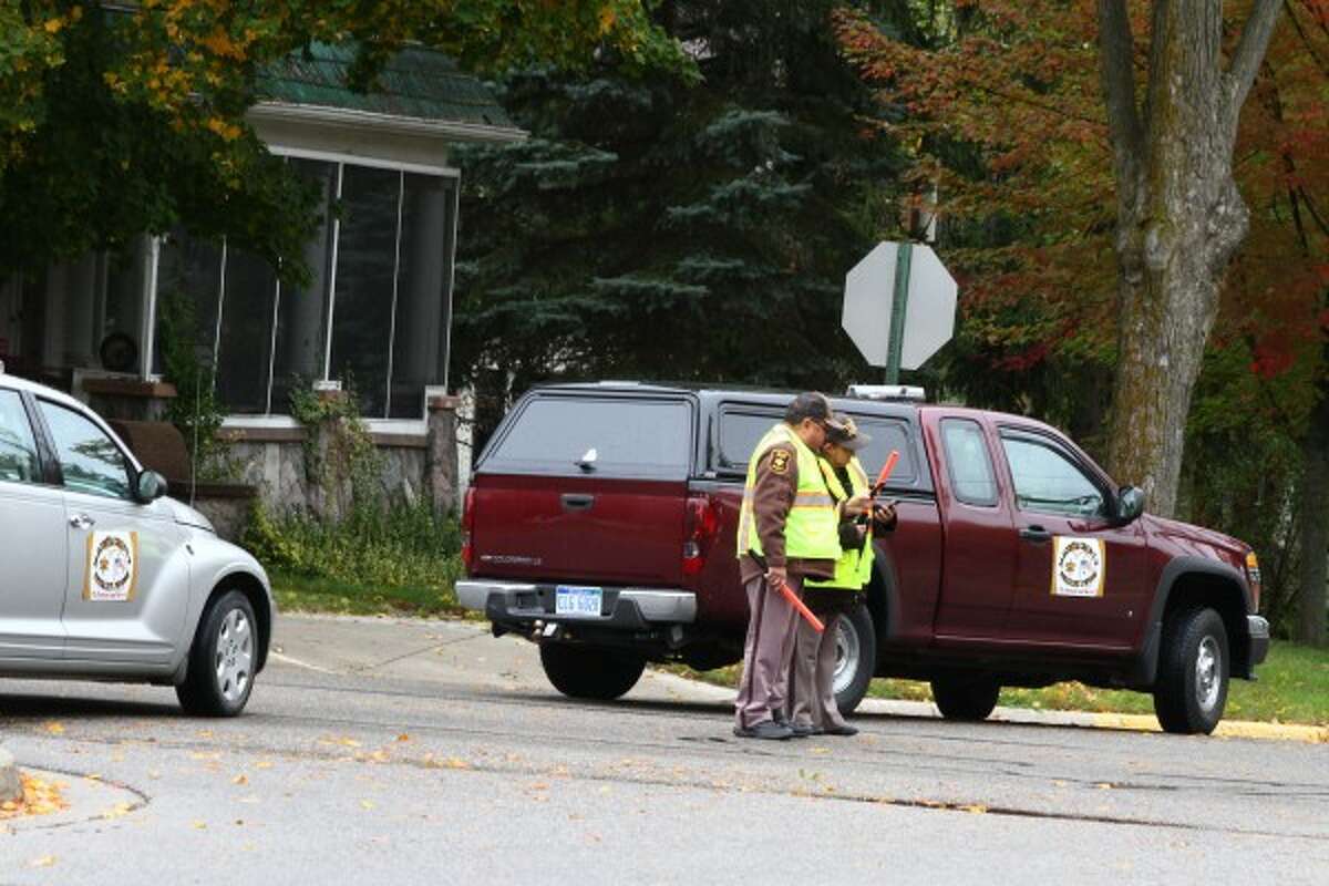NO ENTRY: Members of the Mecosta County Sheriff's Office posse block a portion of Woodward Avenue during Tuesday's training exercise to locate a missing child. (Pioneer photos/Emily Grove-Davis)