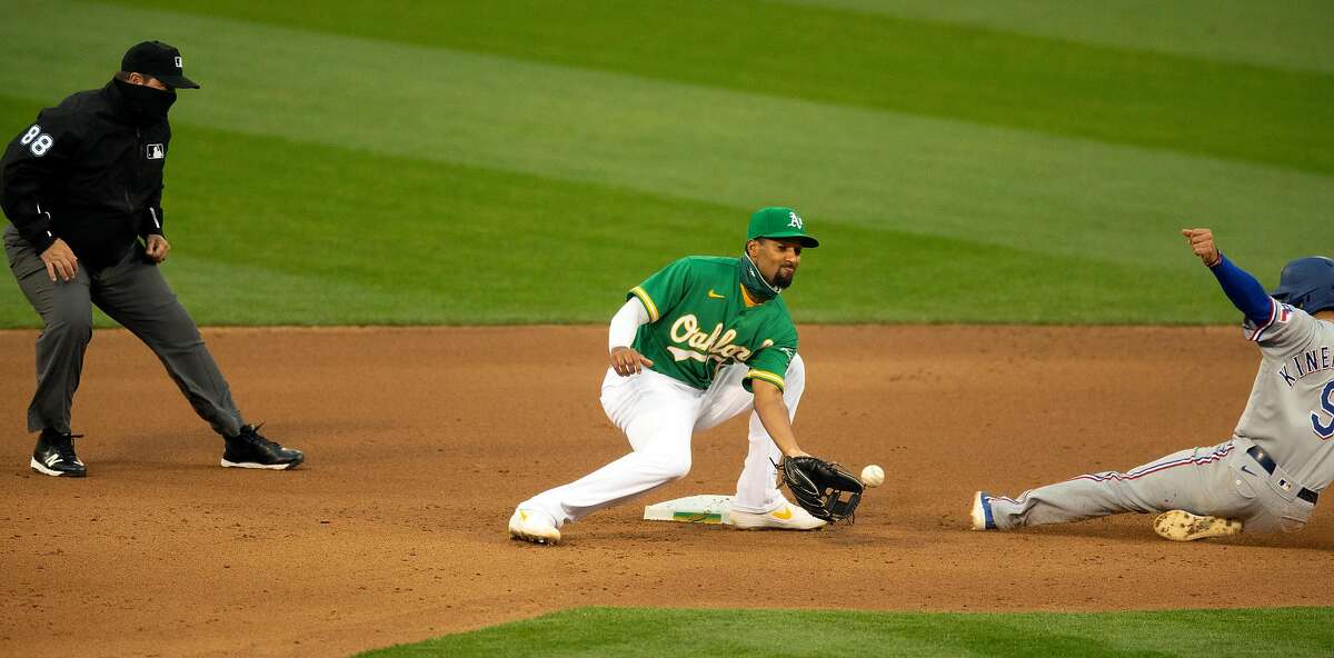 Texas Rangers� Isiah Kiner-Falefa (9) slides safely into second base with a steal ahead of the relay to Oakland Athletics shortstop Marcus Semien (10) during the fourth inning of a Major League Baseball game on Wednesday, Aug. 5, 2020 in Oakland, Calif. Umpire is Doug Eddings.