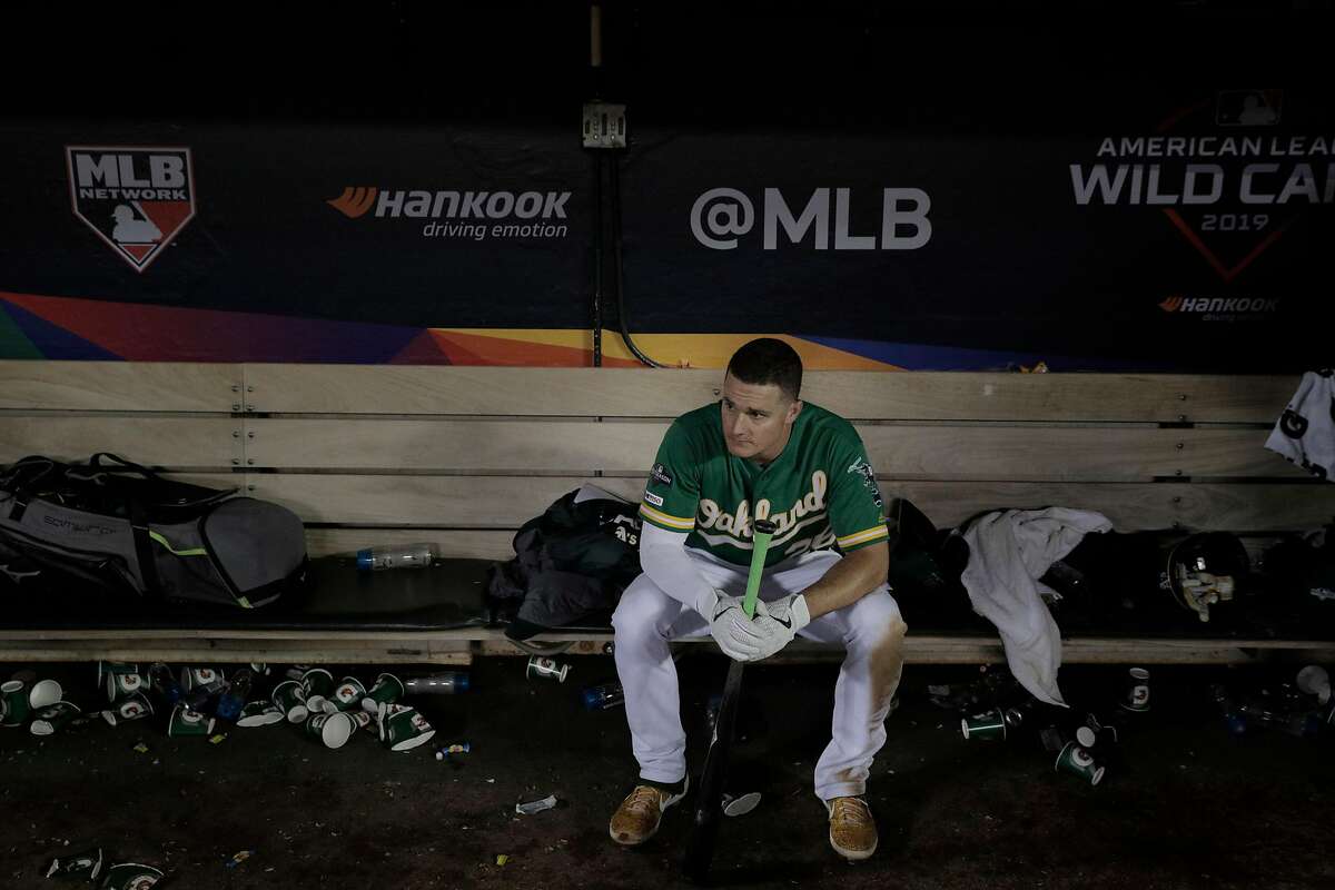 Matt Chapman (26) sits in the dugout after the Oakland Athletics were defeated by the Tampa Bay Rays at the Oakland Coliseum in the AL Wild Card playoff game in Oakland, Calif., on Wednesday, October 2, 2019. The Rays defeated the A’s 5-1.
