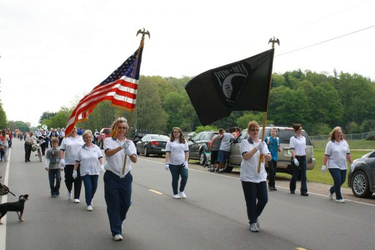 MARCHING: Members of the Women's Auxiliary of American Legion Post No. 554 of Morley marched in the parade to the cemetery, where the women stood in formation behind the speaker's podium during the ceremony. (Pioneer photo/Candy Allan)