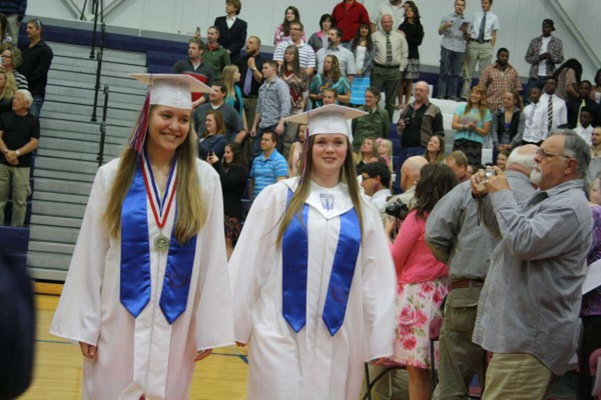 GRAND ENTRANCE: The graduates entered the gymnasium in pairs before heading to their seats, led by Elizabeth Wickes (left) and Paige Baker (right). (Pioneer photo/Candy Allan)