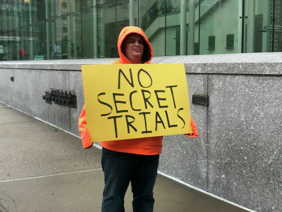 Michael Picard, 30, of South Windsor, protests Thursday outside the Stamford courthouse the new state law closing courtrooms and sealing cases of juveniles charges with felonies.