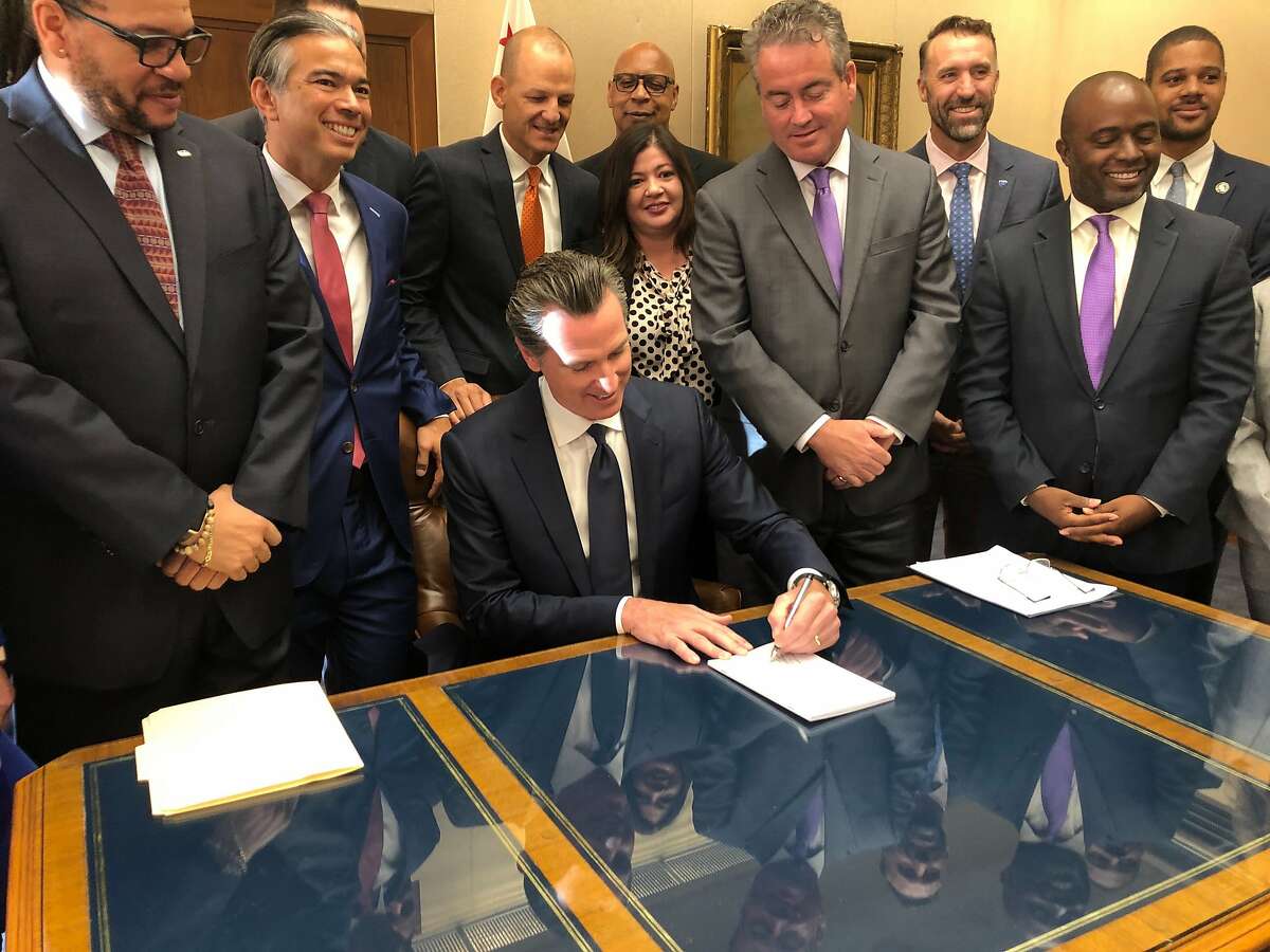 California Gov. Gavin Newsom signs a law overhauling charter schools on Thursday, Oct. 3, 2019, in Sacramento, Calif. The law gives school districts more authority in deciding what charter schools are allowed within their boundaries. (AP Photo/Adam Beam)