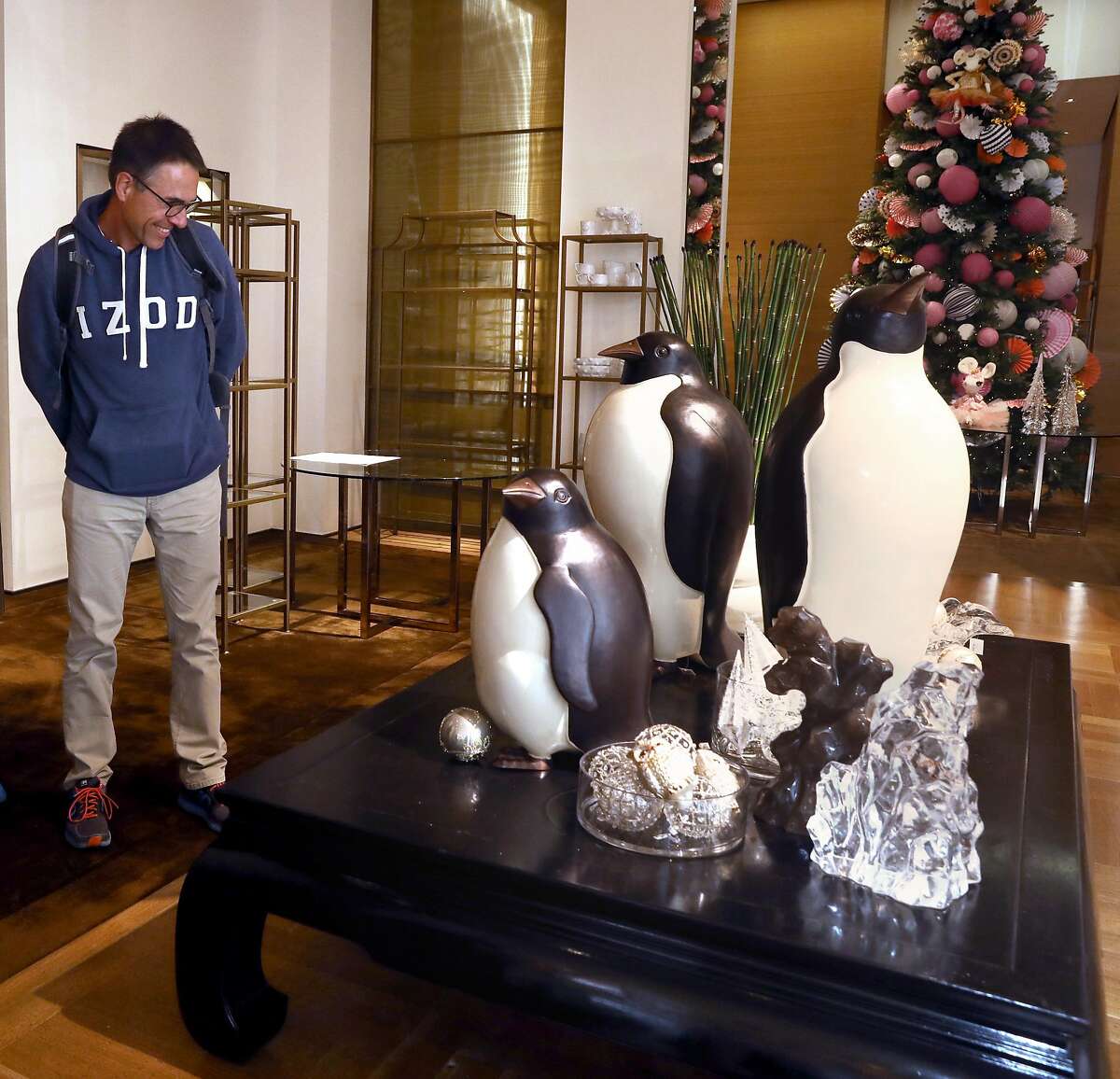 Andreas Huttmann visiting from Germany admires the penguin artwork from Robert Kuo seen at Gump�s which is opening a store in time for the holiday season seen on Post St. near Union Square on Thursday, Oct. 3, 2019, in San Francisco, Calif.