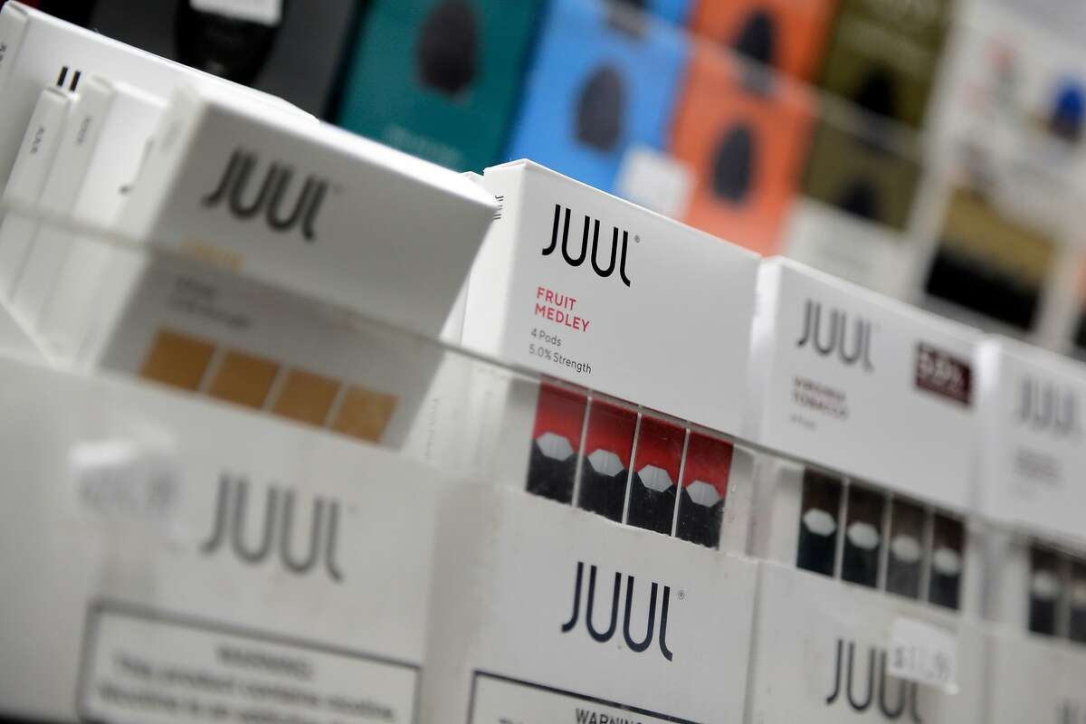 FILE - In this Dec. 20, 2018, file photo Juul products are displayed at a smoke shop in New York. On Thursday, Oct. 3, 2019, the U.S. Federal Trade Commission ordered Juul and five other vaping companies to hand over information about how they market e-cigarettes, the government’s latest move targeting the industry. (AP Photo/Seth Wenig, File)