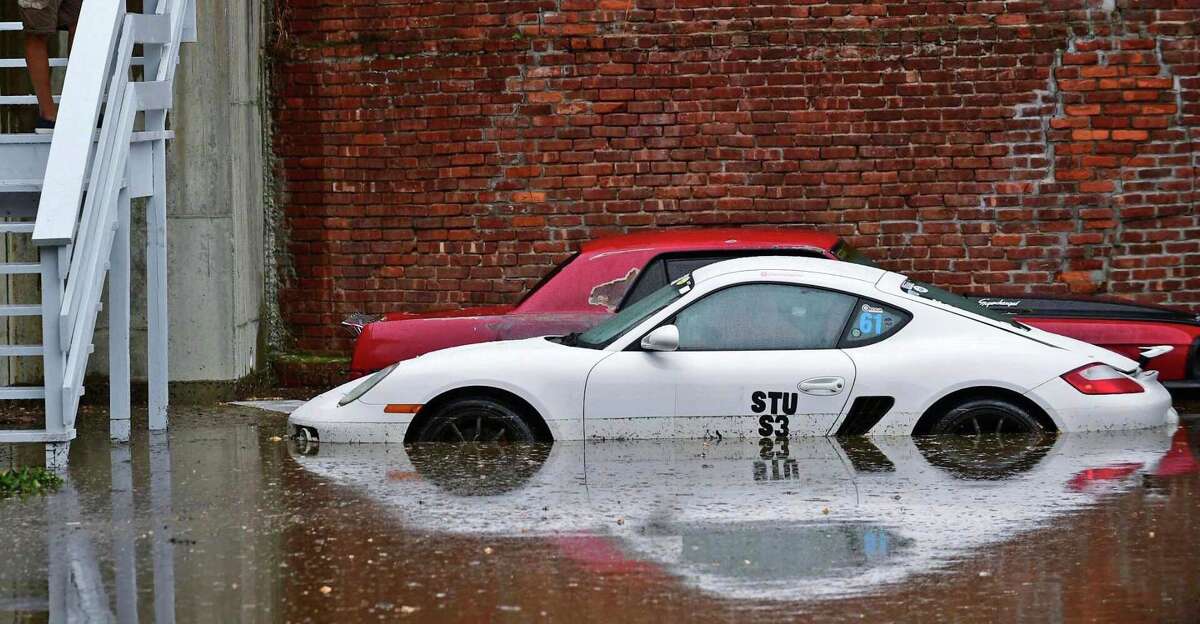 Flooded automobiles in the parking lot of the condominiums Thursday, October 3, 2019, following a water main break on Pine Street Extension in Norwalk, Conn.