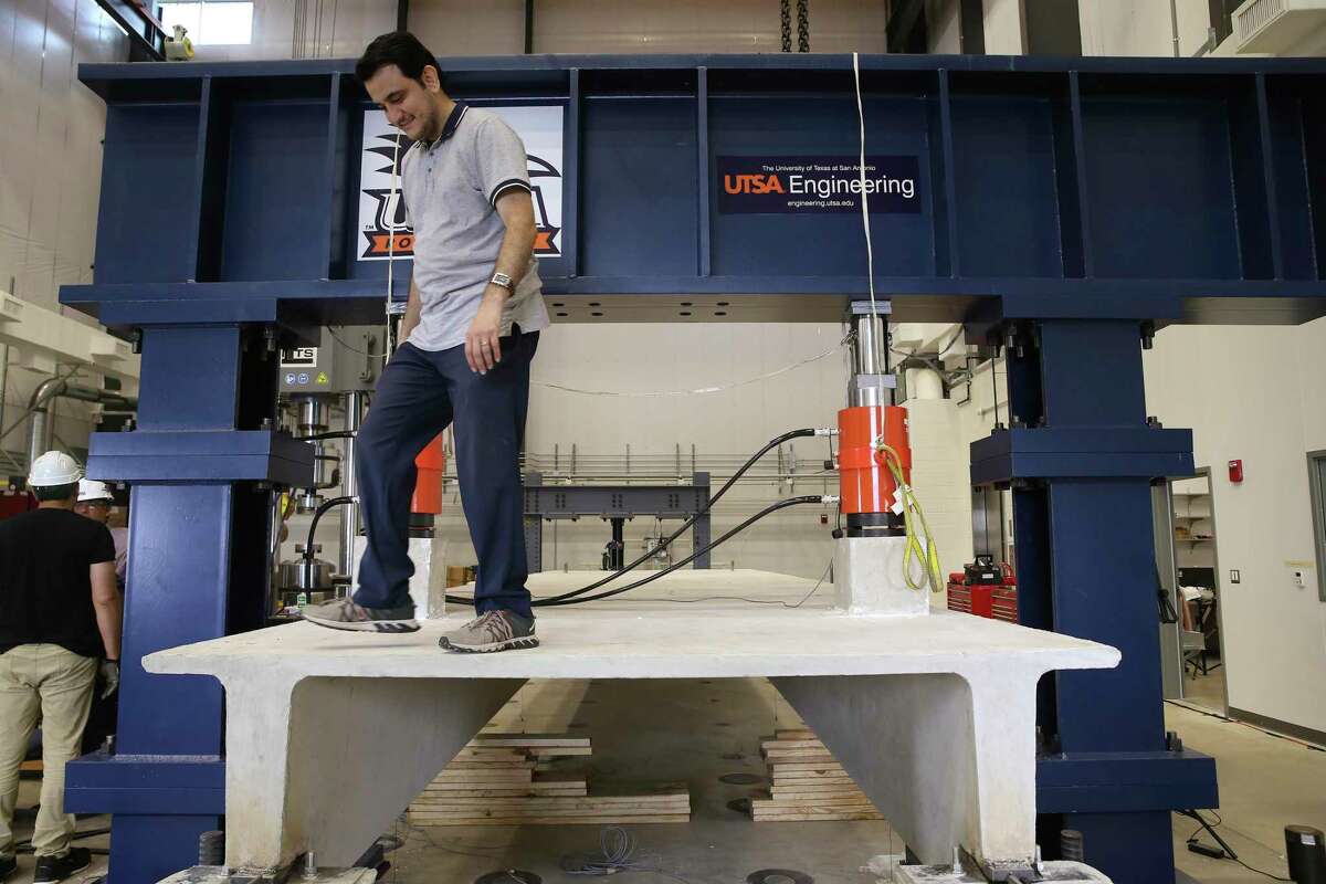 Nader Zad, a doctoral student, checks on equipment used for a live test demonstration at the Large-Scale Testing Lab on Thursday. Pressure was exerted on a concrete girder to the point of fracturing it during the demonstration. The University of Texas at San Antonio inaugurated the facility during a morning ceremony.