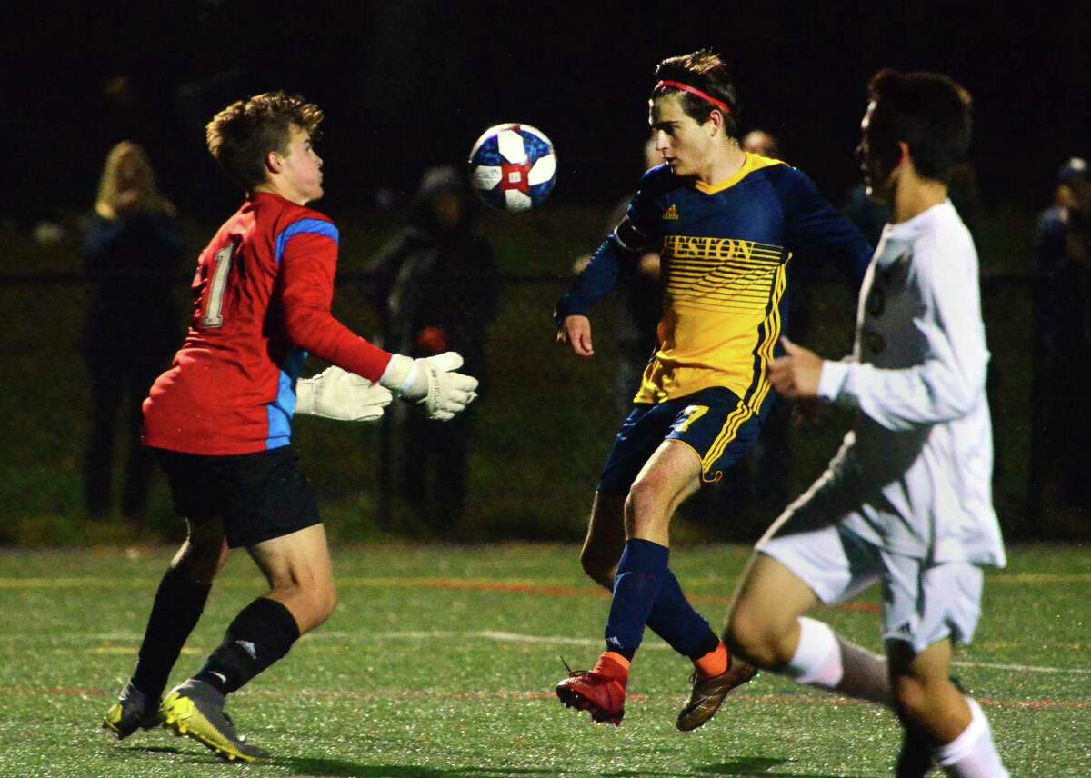 Joel Barlow goalie Will Stewart makes a save as Weston's Mason Asphar converges during boys soccer action in Weston, Conn., on Thursday Oct. 3, 2019.