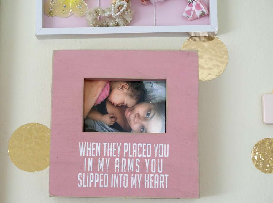 A photo of Ajshay and Harper hangs in the little girl’s room. Photo: Elizabeth Conley/Staff Photographer