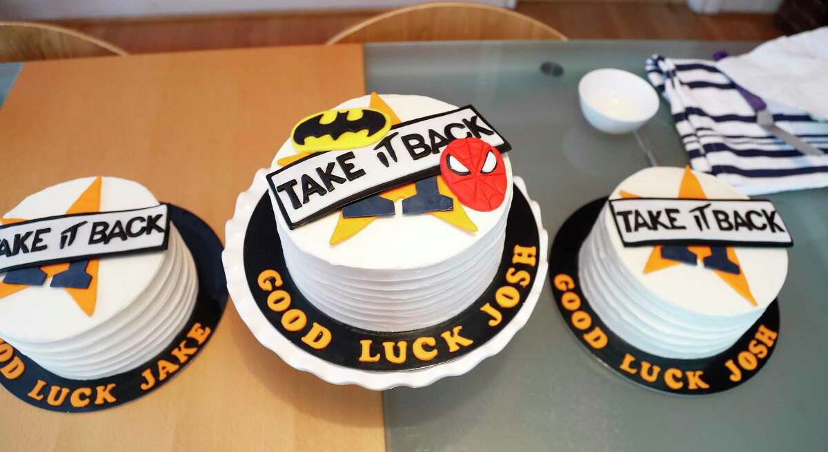 Janet Roush Flood’s “good luck cakes” for Jake Marisnick, Josh Reddick, and Josh James sit on her table. Now that the Astros are in the playoffs, she is baking up a storm in hopes for a World Series win.