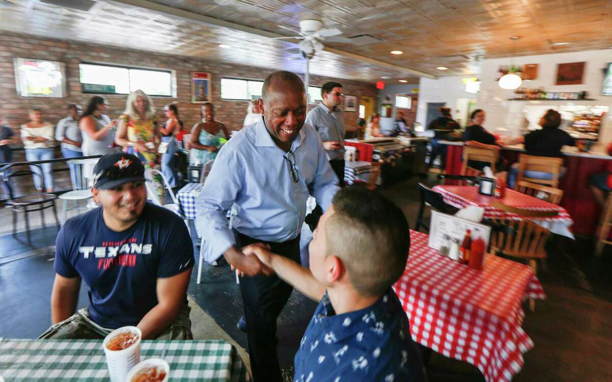 Mayor Sylvester Turner shakes hands with patrons of Gus’s World Famous Fried Chicken last Sunday during the Cigna Sunday Streets Houston on Washington Avenue.