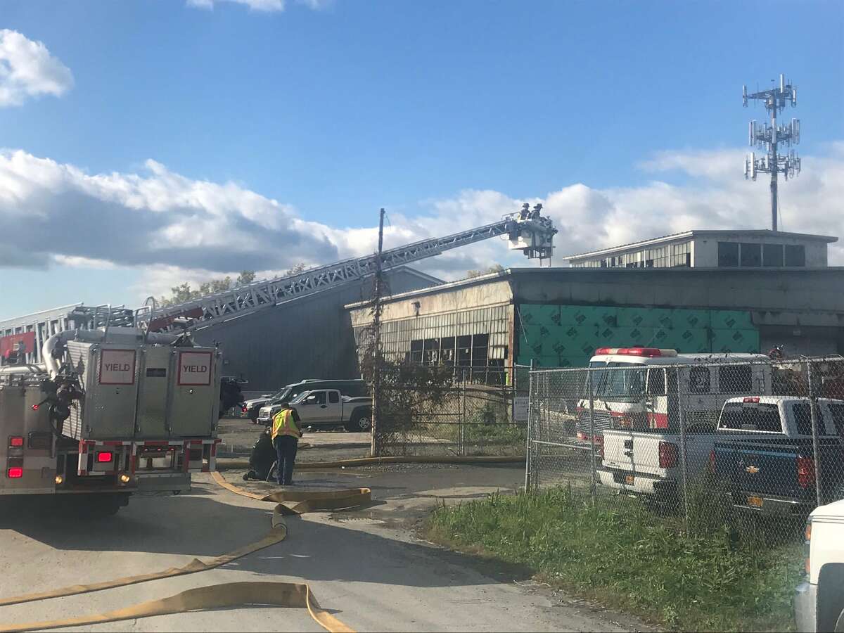 Firefighters are battling a fire that is burning in at least one factory building on Monroe Street in Troy. Fire can be seen billowing from one of two factory buildings.