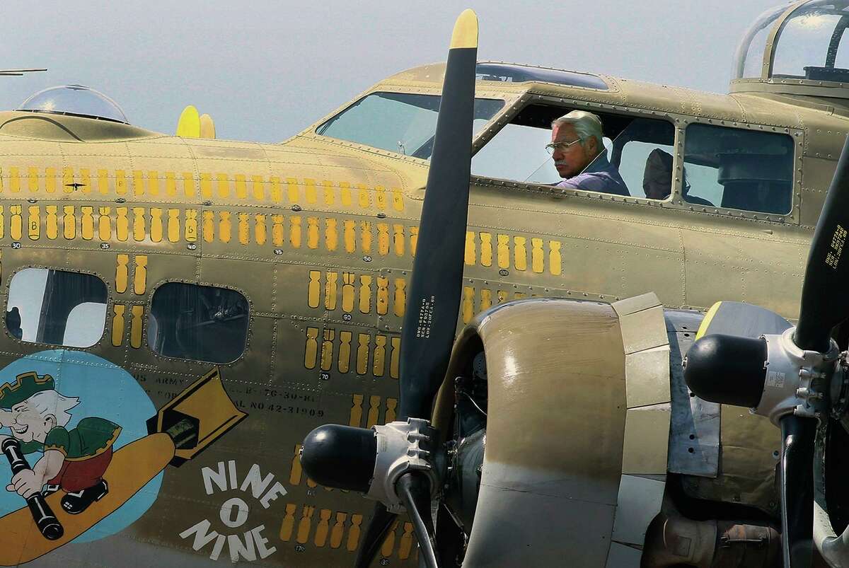 FILE - In this Aug. 19, 2019 file photo, B-17 pilot, Ernest "Mac" McCauley sits in the cockpit after landing at Hazleton Regional Airport for The Wings of Freedom Tour in Hazle Township, Pa. McCauley, 75, of Long Beach, Calif., and his co-pilot were among seven people killed when the bomber crashed and burned Wednesday, Oct. 2, 2019, at Bradley International Airport in Windsor Locks, Conn.