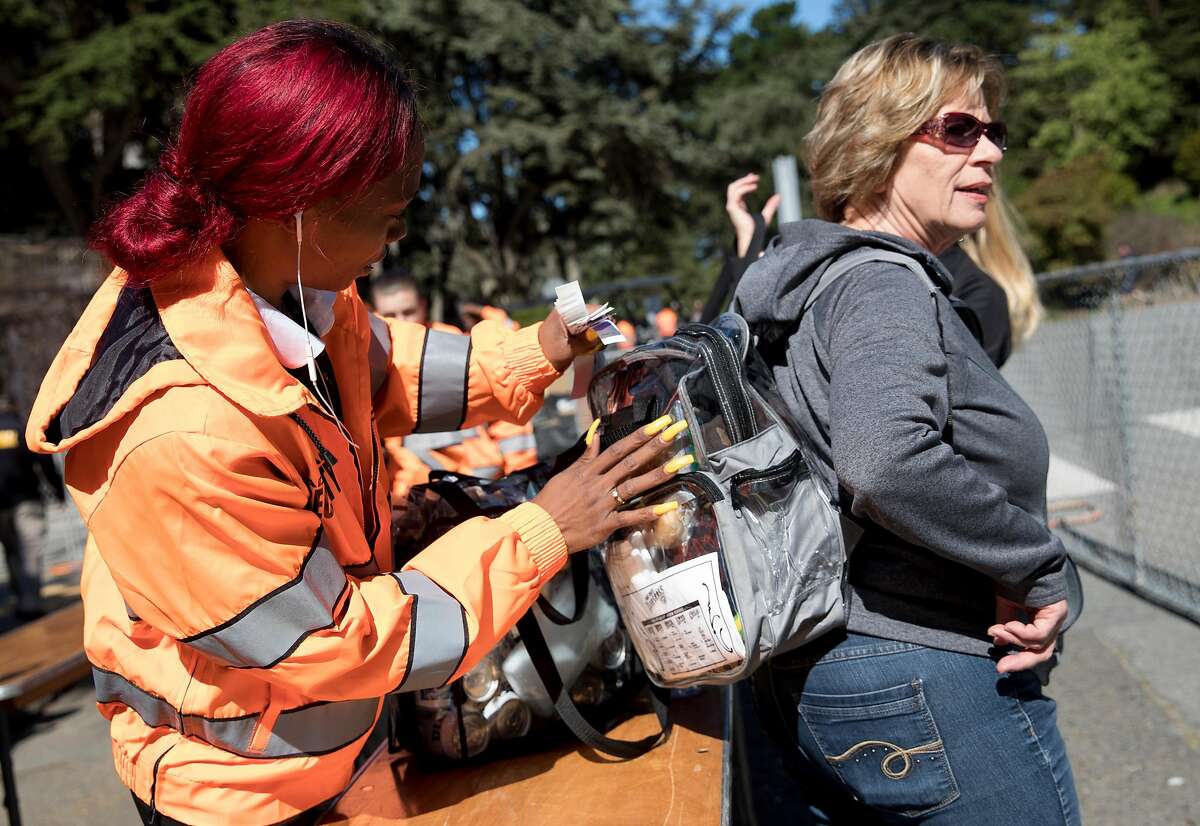 Festival attendees have their bags checked by security during the Hardly Strictly Bluegrass Festival held at Golden Gate Park in San Francisco, Calif. Friday, Oct. 4, 2019.