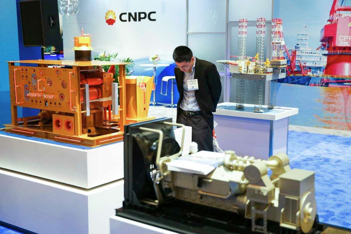 A man looks at a model of a CNPC Horizontal Subsea Christmas Tree during the Offshore Technology Conference.