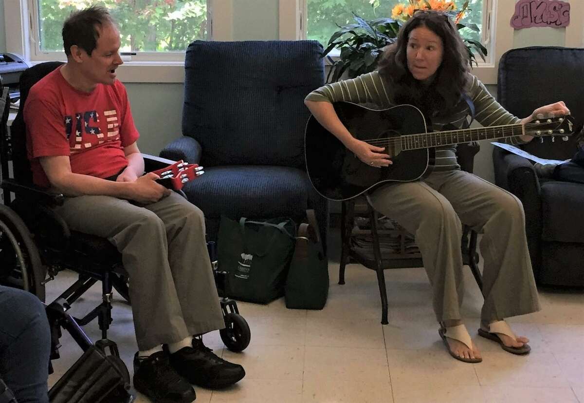Twice a week, LARC’s Day Services Program participants at both the Main Street and Migeon Street LARC locations, engage in a lively hour of music. Music therapist Meg Capen, right, is joined by Larry Dickinson during a recently music therapy class.